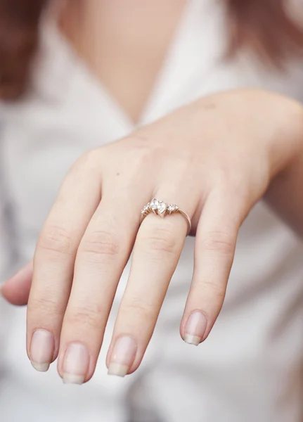 Engagement ring inserted into finger — Stock Photo, Image