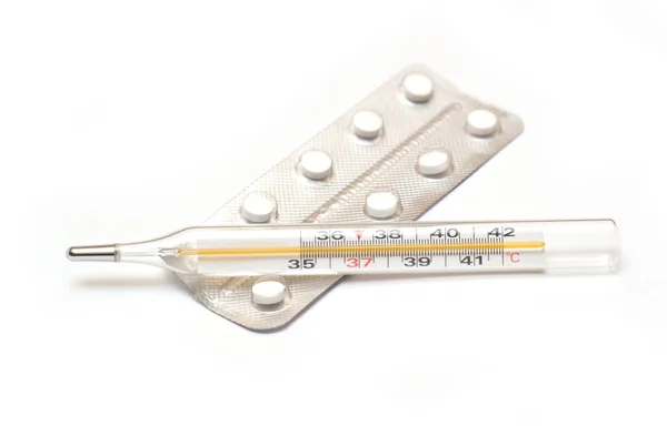 Medicine pills and thermometer isolated — Stock Photo, Image