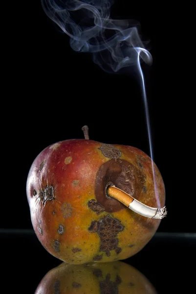 Apple and smoking butt look like worm — Stock Photo, Image
