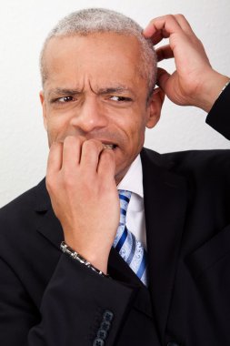 Stressed Businessman Biting His Nails clipart
