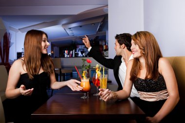 Man ordering drinks while girls having fun clipart