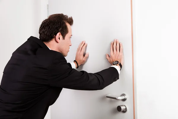 Businessman pushing the door — Stock Photo, Image