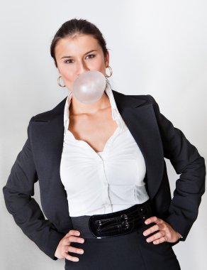 Businesswoman blowing the bubblegum. Market bubble concept clipart