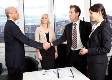 Business handshake over the deal at office clipart