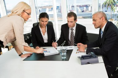 Women giving instructions to the business team clipart