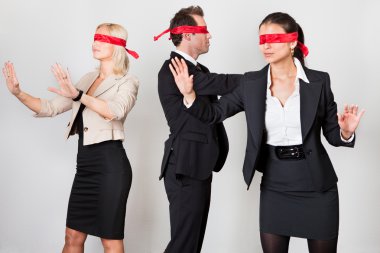 Group of disoriented businesspeople with red ribbons on eyes clipart