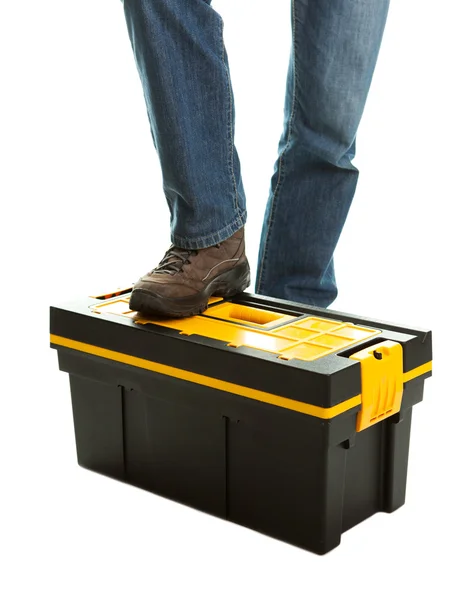 Close-up of repairman standing on toolbox — Stock Photo, Image