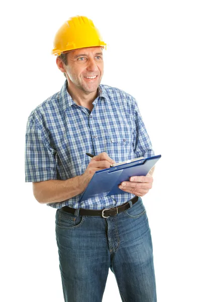 Trabalhador usando chapéu duro e tomar notas — Fotografia de Stock