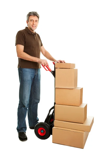 Uomo di consegna con camion a mano e pila di scatole — Foto Stock