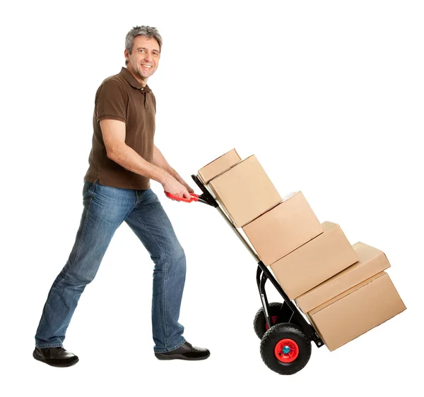 Uomo di consegna spingendo camion a mano e pila di scatole — Foto Stock