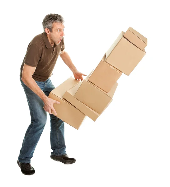 Entrega homem com queda pilha de caixas — Fotografia de Stock