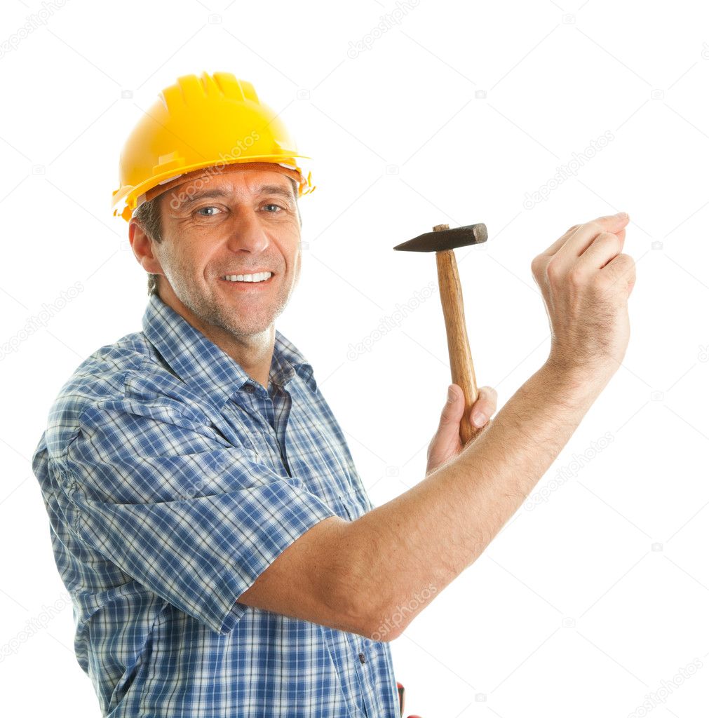 Confident worker hammering in