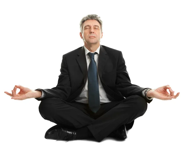 Uomo d'affari seduto in posizione yoga — Foto Stock