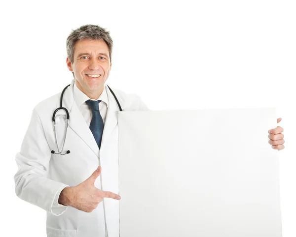 Smiling medical doctor presenting empty board — Stock Photo, Image