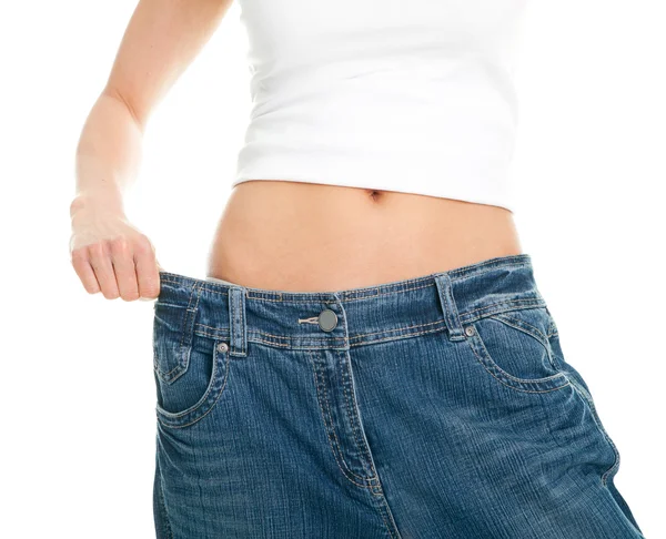 Slanke vrouw trekken oversized jeans — Stockfoto