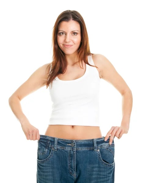 Štíhlá žena tahání nadrozměrných džíny — Stock fotografie