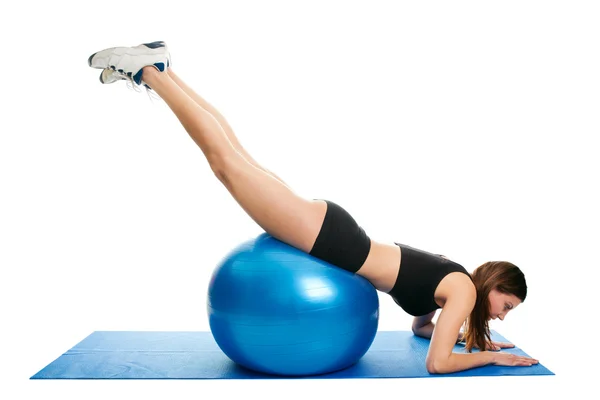 Young woman doing roll-out on the fitness ball — Stock Photo, Image