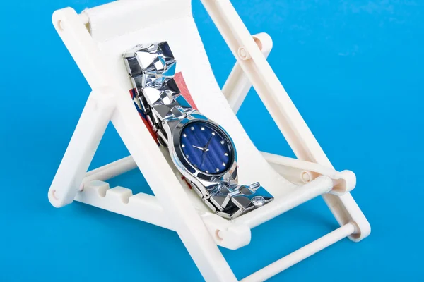 Ένα Ρολόι Χειρός Που Αναπαύεται Στις Ξαπλώστρες Μπλε Φόντο — Φωτογραφία Αρχείου