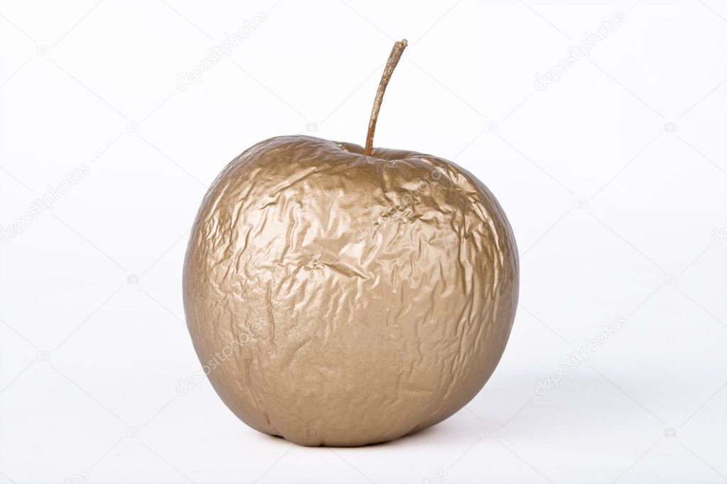 Contracted golden dry apple against white background
