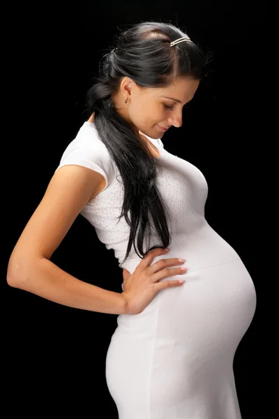 Těhotná na černém pozadí — Stock fotografie