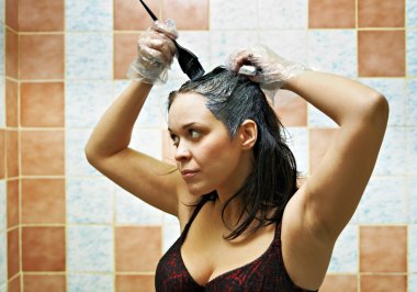 Woman dyeing hairs clipart