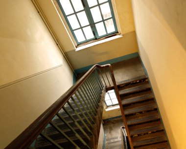 Looking down at an old wooden stairs at an abandoned building clipart