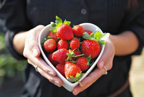 Strawberries in heart shape bowl — Stock Photo, Image