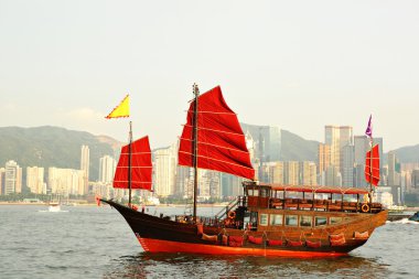 Hong Kong harbor with red sail boat clipart