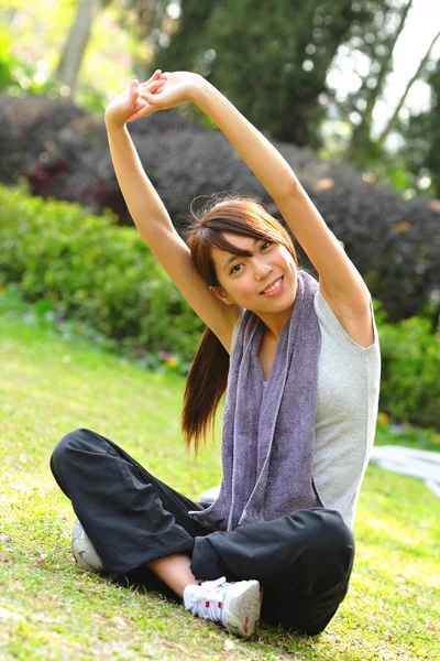 Kvinnan gör stretching övning i park — Stockfoto