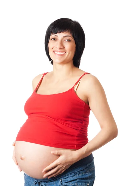 Lachende zwangere vrouw omarmt zijn maag — Stockfoto