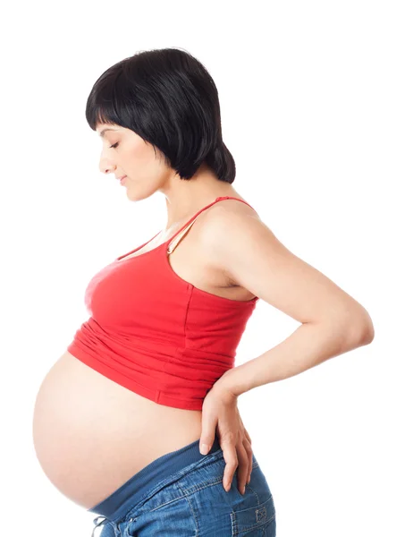 Schwangere in Seitenansicht mit geschlossenen Augen über weißem Hintergrund Stockbild