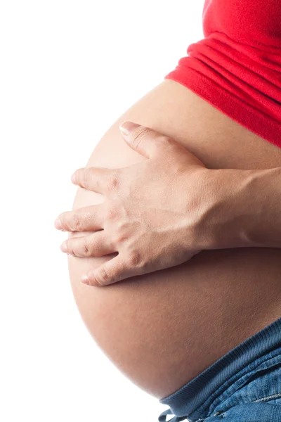 Mulher grávida segurando sua barriga com as mãos Fotografia De Stock
