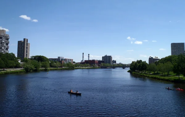 stock image rowing in boats on the Charles river by Harvard University taken on bridge.