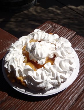 Funnel Cake enjoyed at a picnic table in a park clipart