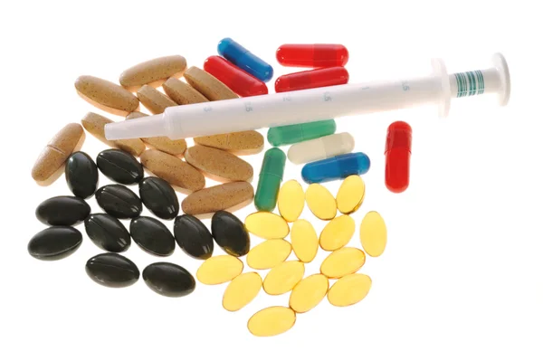 Pills and a syringe — Stock Photo, Image