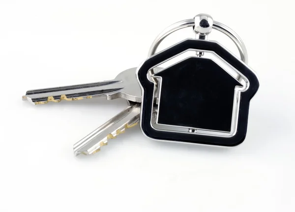 Twee zilveren sleutels met metalen huis figuur — Stockfoto