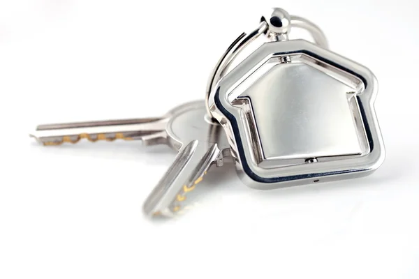 Due chiavi d'argento con figura casa in metallo Fotografia Stock