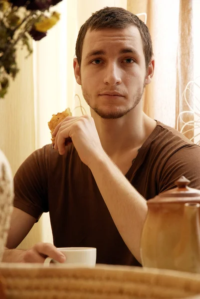 stock image a young guy having a breakfast in the kitchen