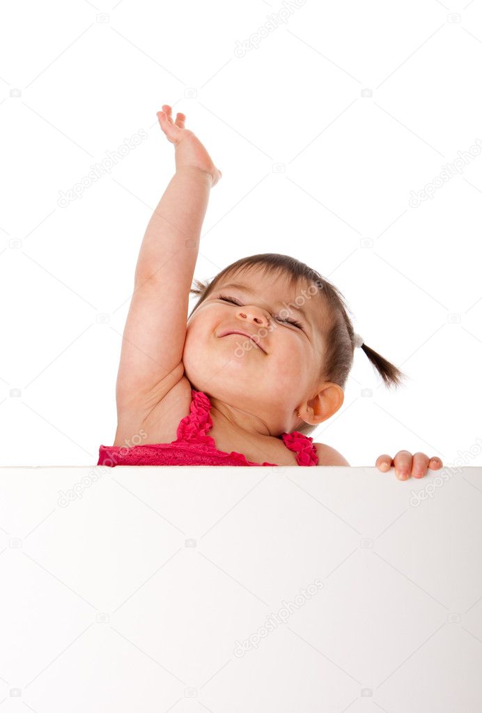 Happy baby holding white board and reaching up