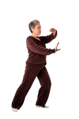 Senior woman doing Tai Chi Yoga exercise clipart