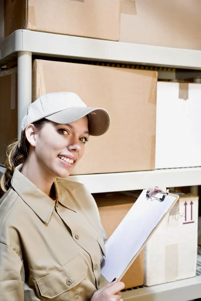 stock image Woman worker taking inventory in a warehouse