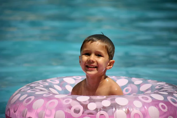 Jeune garçon jouant dans une piscine — Photo
