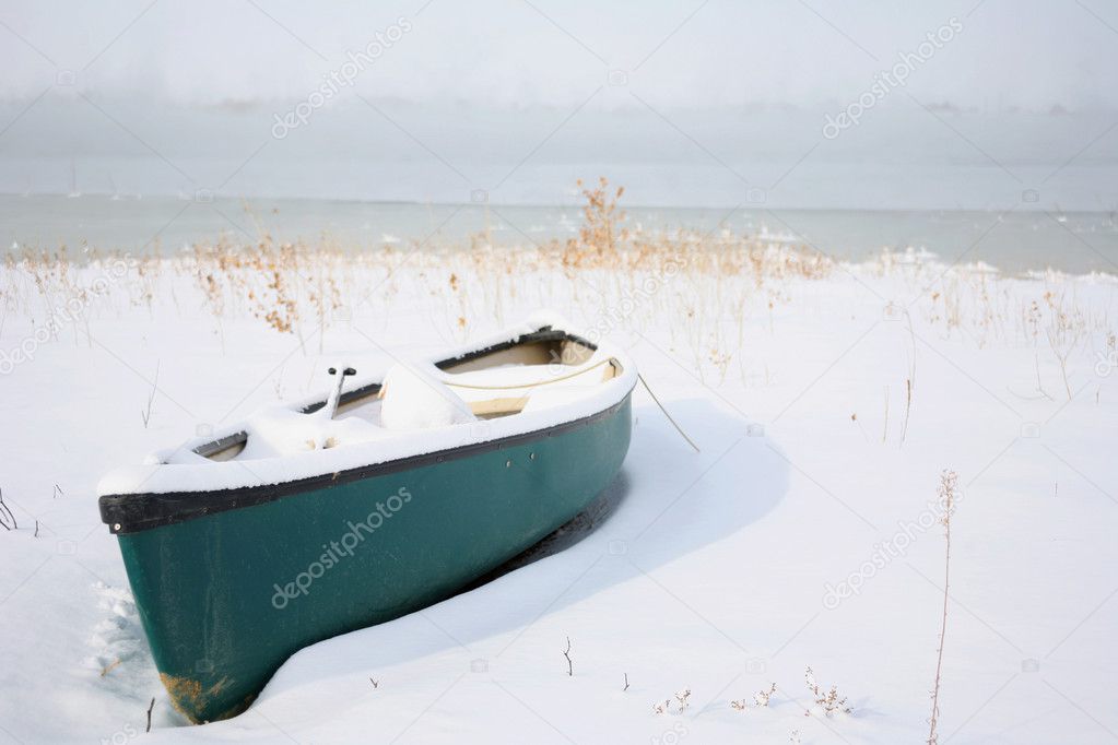 Canoe on the beach covered in snow