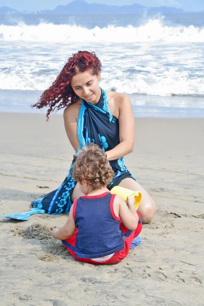 एक तरुण कुटुंब समुद्रकिनारावर एकत्र खेळतो — स्टॉक फोटो, इमेज