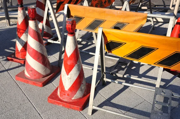 Prohibition cones and temporary signs placed on pavement in road construction area