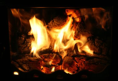 Fire in chimney on black background clipart