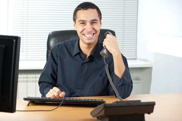 Businessman talking on telephone in office