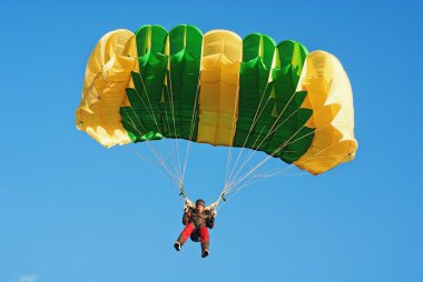The guy parachutist in red overalls clipart