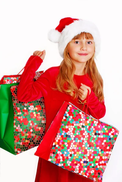 Молода дівчина в тканині Санта з подарунковими пакетами — стокове фото