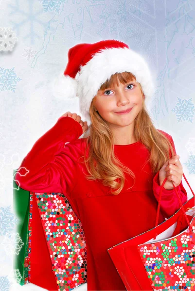 Young girl in santa cloth with gift bags — Stock Photo, Image